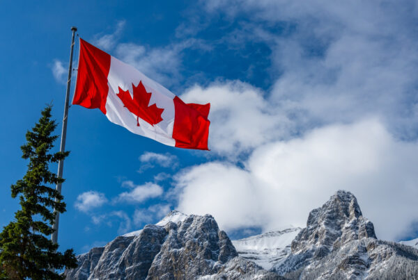 close up national flag canada with natural mountains trees scenery background ()