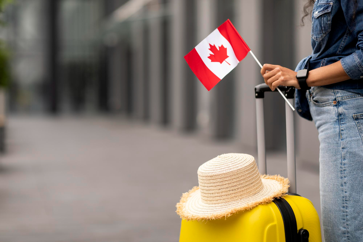 cropped woman traveller holding flag canada going abroad